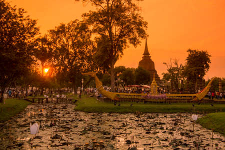 a taditional boat and a temple at the Loy Krathong Festival in the Historical Park in Sukhothai in the Provinz Sukhothai in Thailand.   Thailand, Sukhothai, November, 2019のeditorial素材