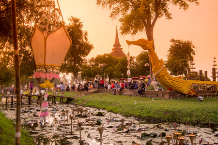 a traditional boat and a temple stupa at the Loy Krathong Festival in the Historical Park in...