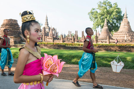 traditional dresst thai people at the Loy Krathong Festival in front of the Wat mahathat in the Historical Park in Sukhothai in the Provinz Sukhothai in Thailand.   Thailand, Sukhothai, November, 2019のeditorial素材