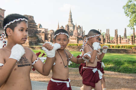 muay Thai boxing boys at the Loy Krathong Festival in front of the Wat mahathat in the Historical Park in Sukhothai in the Provinz Sukhothai in Thailand.   Thailand, Sukhothai, November, 2019のeditorial素材