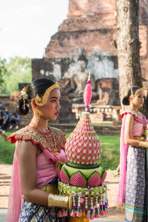 traditional dresst thai people at the Loy Krathong Festival in front of the Wat mahathat in the Historical Park in Sukhothai in the Provinz Sukhothai in Thailand.   Thailand, Sukhothai, November, 2019のeditorial素材