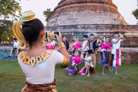 traditional dresst thai people at the Loy Krathong Festival in front of the Wat mahathat in the Historical Park in Sukhothai in the Provinz Sukhothai in Thailand.   Thailand, Sukhothai, November, 2019のeditorial素材