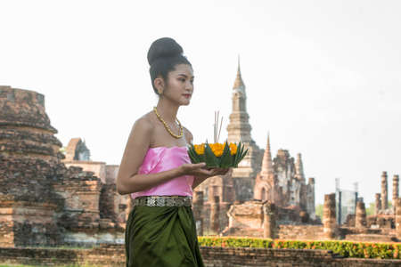 traditional dresst thai people at the Loy Krathong Festival in front of the Wat mahathat in the Historical Park in Sukhothai in the Provinz Sukhothai in Thailand.   Thailand, Sukhothai, November, 2019のeditorial素材