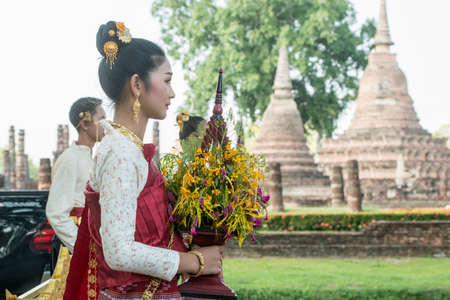 traditional dresst thai people at the Loy Krathong Festival in front of the Wat mahathat in the Historical Park in Sukhothai in the Provinz Sukhothai in Thailand.   Thailand, Sukhothai, November, 2019のeditorial素材
