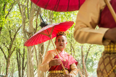 traditional dresst thai people at the Loy Krathong Festival in the Historical Park in Sukhothai in the Provinz Sukhothai in Thailand.   Thailand, Sukhothai, November, 2019のeditorial素材