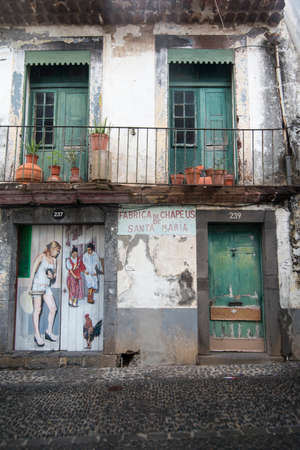street  and wall art at the old houses in the old town of zona Velha in the old city of Funchal at night on the Island Madeira of Portugal.   Portugal, Madeira, April 2018のeditorial素材