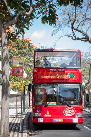 a tour bus in the city centre of Funchal on the Island Madeira of Portugal.   Portugal, Madeira, April 2018のeditorial素材