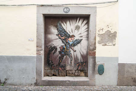 street  and wall art at the old houses in the old town of zona Velha in the old city of Funchal at night on the Island Madeira of Portugal.   Portugal, Madeira, April 2018のeditorial素材