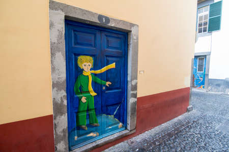 street  and wall art at the old houses in the old town of zona Velha in the old city of Funchal at night on the Island Madeira of Portugal.   Portugal, Madeira, April 2018のeditorial素材