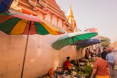 the marketstreet in front of the Wat Mung Muang at the Kad Luang Market in the city of Chiang Rai in North Thailand.  Thailand, Chiang Rai, November, 2019のeditorial素材