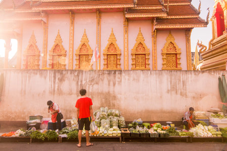 the marketstreet in front of the Wat Mung Muang at the Kad Luang Market in the city of Chiang Rai in...