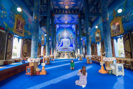 the Buddha statue in the Blue Temple or Wat Rong Suea Ten in the city of Chiang Rai in North Thailand.  Thailand, Chiang Rai, November, 2019のeditorial素材