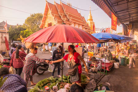 the marketstreet in front of the Wat Mung Muang at the Kad Luang Market in the city of Chiang Rai in North Thailand.  Thailand, Chiang Rai, November, 2019のeditorial素材