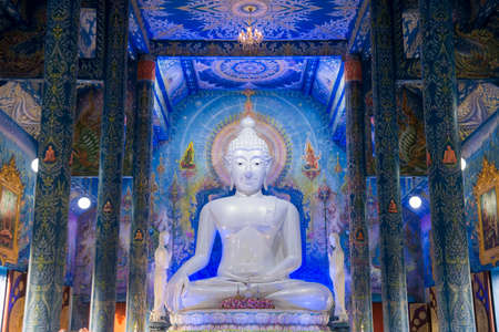 the Buddha statue in the Blue Temple or Wat Rong Suea Ten in the city of Chiang Rai in North Thailand.  Thailand, Chiang Rai, November, 2019のeditorial素材
