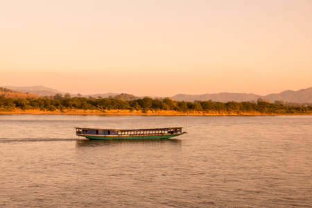 a sunset at the mekong river in the town of Chiang Saen in the north of the city Chiang Rai in North Thailand.   Thailand, Chiang Sean, November, 2019のeditorial素材