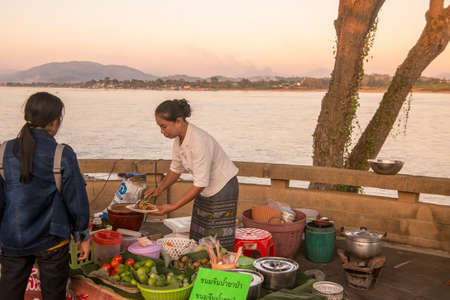 street food at a Satuday night market at the mekong river in the town of Chiang Saen in the north of the city Chiang Rai in North Thailand.   Thailand, Chiang Sean, November, 2019のeditorial素材