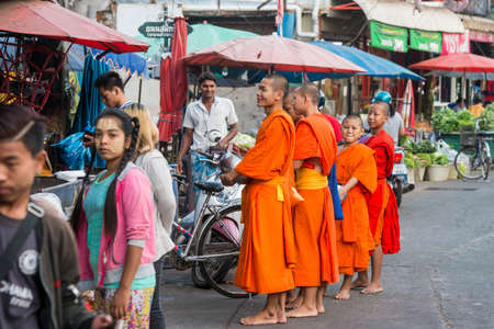 monks in the morning at the Flower market in the marketstreet in the old Town of Mae Sot in the Province of Tak in Tahiland.   Thailand, Mae Sot, November, 2019のeditorial素材
