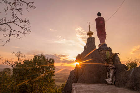 a Temple Shrine of a Monk from Myanmar on a Top of a Rock on the Thailand and Myanmar Border near the Phra That  Doi Din Chi near the town of Mae Sot in the Province of Tak in Tahiland.   Thailand, Mae Sot, November, 2019のeditorial素材