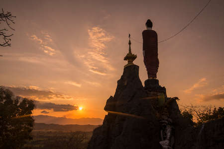 a Temple Shrine of a Monk from Myanmar on a Top of a Rock on the Thailand and Myanmar Border near the Phra That  Doi Din Chi near the town of Mae Sot in the Province of Tak in Tahiland.   Thailand, Mae Sot, November, 2019のeditorial素材