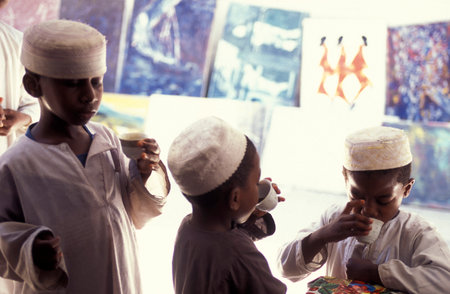 a School Boy with a Tea in the Old Town of Stone Town on the Island of Zanzibar in Tanzania.  Tanzania, Zanzibar, Stone Town, October, 2004のeditorial素材