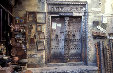 a traditional Wood Door in the Old Town of Stone Town on the Island of Zanzibar in Tanzania.  Tanzania, Zanzibar, Stone Town, October, 2004のeditorial素材