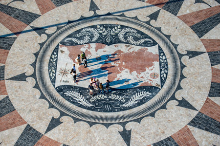 People walk on the giant world Map Mosaic or pavement at the Padrao dos Descobrimentos in Belem near...