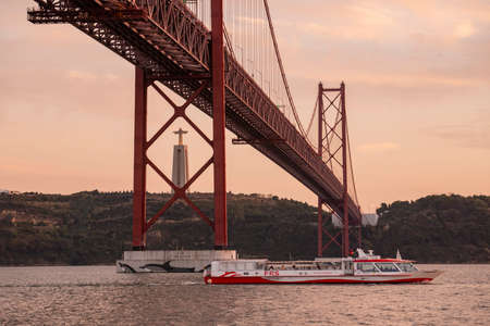 the Cristo Rei Statue and the Ponte 25 de Abril or 25the April Bridge at the Rio Tejo near the City of Lisbon in Portugal.  Portugal, Lisbon, October, 2021のeditorial素材