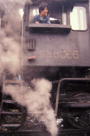 a steam Locomotive Train in the City of Wuhan in the Province of Hubei in China.  China, Wuhan, November, 1996のeditorial素材