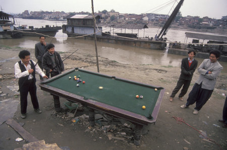 people play pool at the Port on the Yangtze River in the City of Wuhan in the Province of Hubei in...