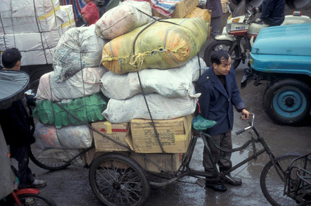Traffic Jam with goods Carrier at the Marketstreet near the Market and the Bus Terminal in the City of Wuhan in the Province of Hubei in China.  China, Wuhan, November, 1996のeditorial素材