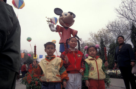 Children at a Park in the City of Kaifeng in the Province of Henan in China. China, Kaifeng, November, 1996のeditorial素材