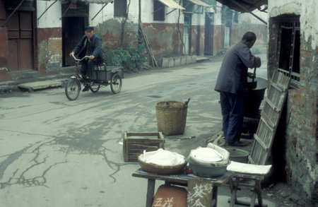 street life in a small alley in the old town in the City of Kaifeng in the Province of Henan in China. China, Kaifeng, November, 1996のeditorial素材