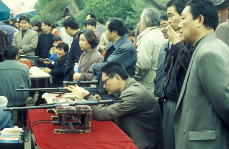 people at the Park in the Memorial Temple to Lord Bao in the City of Kaifeng in the Province of Henan in China. China, Kaifeng, November, 1996のeditorial素材