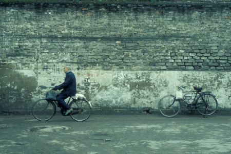 a bicycle on a street in the City of Kaifeng in the Province of Henan in China. China, Kaifeng, November, 1996のeditorial素材