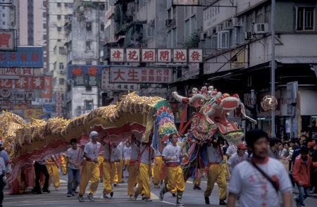 a Dragon Dance parade in Downtown Yuen Long in Hong Kong. Hong Kong, April, 1999のeditorial素材