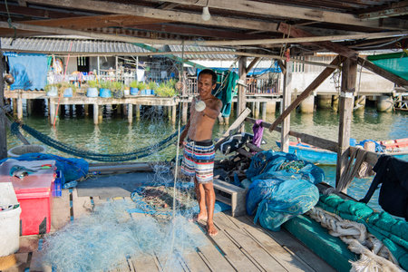 a fishermen at work in the Fishing Village of Sattahip in the province of Chonburi in Thailand,...