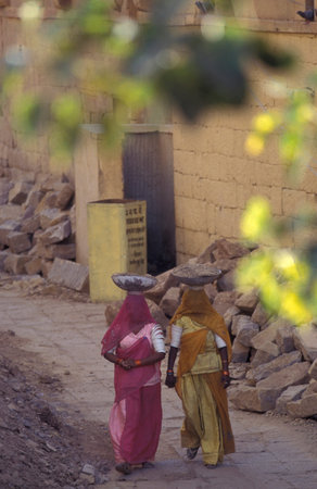 two Rajasthani women at a construction work in the Town of Jaisalmer in the Province of Rajasthan in India. India, Jaisalmer, January, 1998のeditorial素材
