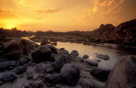 the Landscape and River with the typical Stones and Hills around the town of Hampi in the Province of Karnataka in India. India, Karnataka, March, 1998のeditorial素材