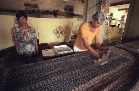 a men at a Family Factory of hand made Batik Textile print at work in the city of Mysore in the...