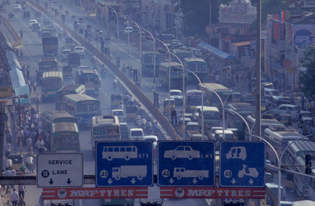 Traffic and pollution with cars, bus amd motorcycle on a mainroad in the city of Chennai in Tamil...