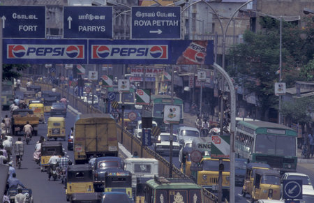 Traffic and pollution with cars, bus amd motorcycle on a mainroad in the city of Chennai in Tamil...