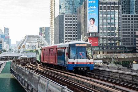 a skytrain with high buildings in Sathorn in the city of Bangkok in Thailand. Thailand, Bangkok,...