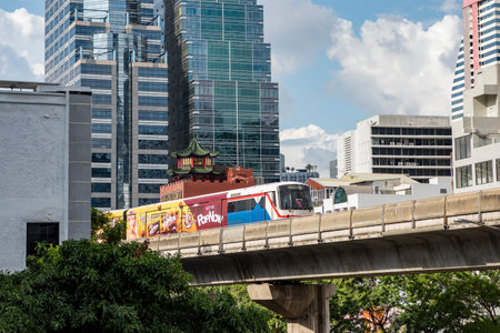 a skytrain with high buildings in Sathorn in the city of Bangkok in Thailand. Thailand, Bangkok,...