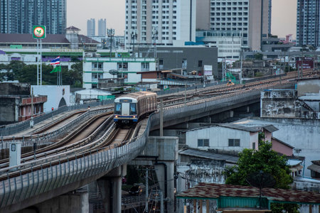 a skytrain with high buildings in Thonburi in the city of Bangkok in Thailand. Thailand, Bangkok,...