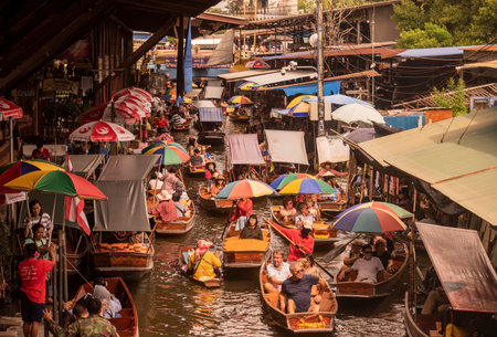 Tourboat taxis with tourists driving allround a khlong at Damnoen Saduak river and Floating market...