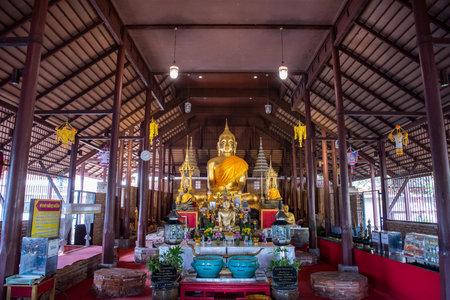 two Buddha statues at Wat Mahathat Worawihan in the city and Province of Ratchaburi in Thailand,...