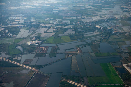 an aerial view of the agriculture fields in the Province of Pathum Thani in Thailand. Thailand,...