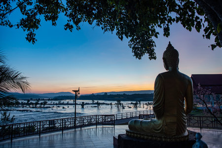 Buddha at Wat Khong Chiam at Two Color River viewpoint in Town of Khong Chiam in Province of Ubon Ratchathani in Thailand. Thailand, Khong Chiam, November, 28, 2023のeditorial素材