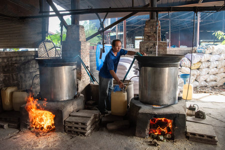 Production of Rice Spirits at Factory Sura Sak Thong in Sa-iap Village in Province of Phrae in North Thailand. Thailand, Phrae, November, 25, 2024.のeditorial素材