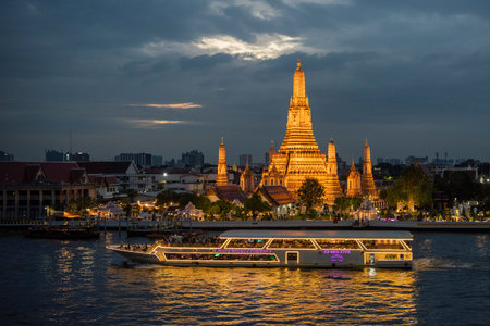 Cruise Boat at Wat Arun at Chao Phraya River in City of Bangkok in Thailand. Thailand, Bangkok, December,13, 2024.のeditorial素材